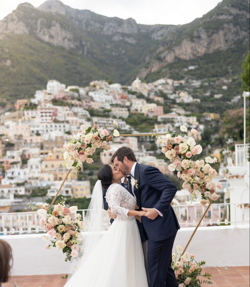 bride and groom kissing on their wedding day in Positano