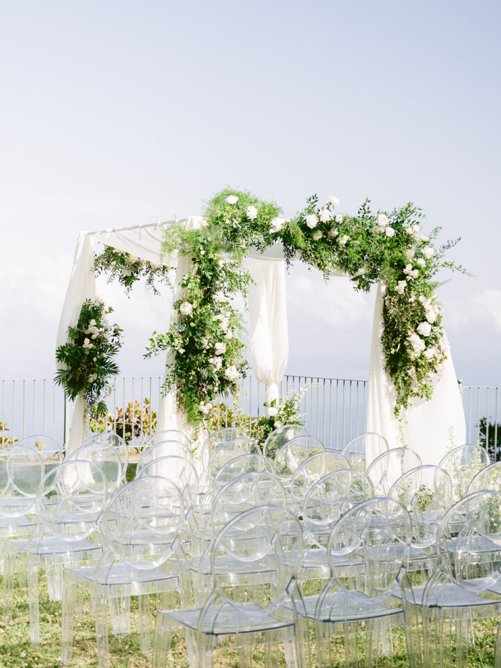 chuppah with white flowers and greenery for a Jewish wedding in Ravello with Kartell chairs