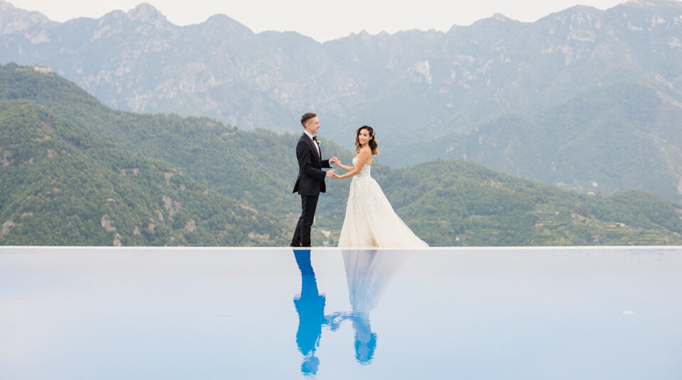 bride and groom on the edge of the pool at the Belmond Caruso in Ravello