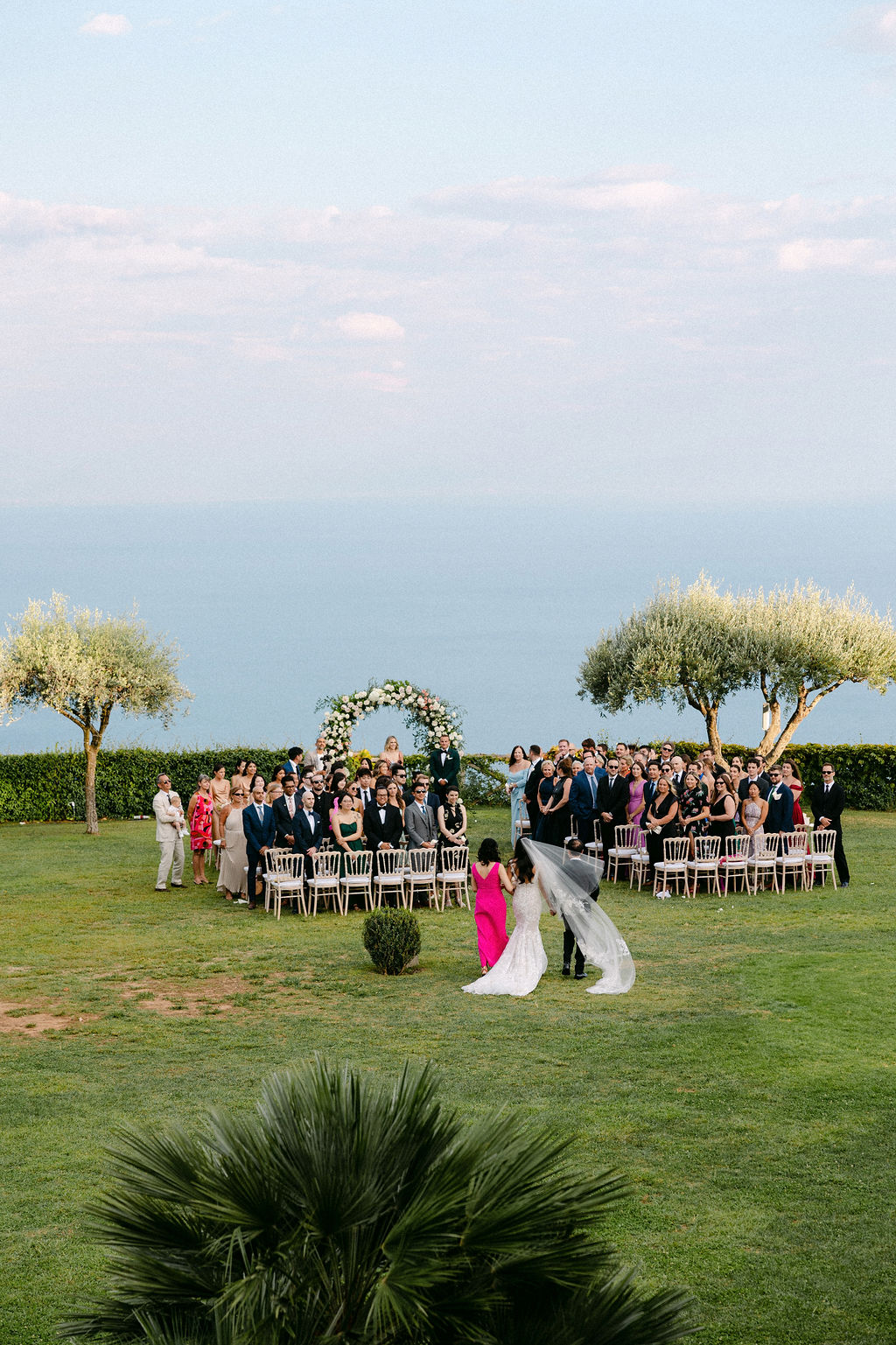 Bride walks down the aisle with her parents at Villa Cimbrone wedding