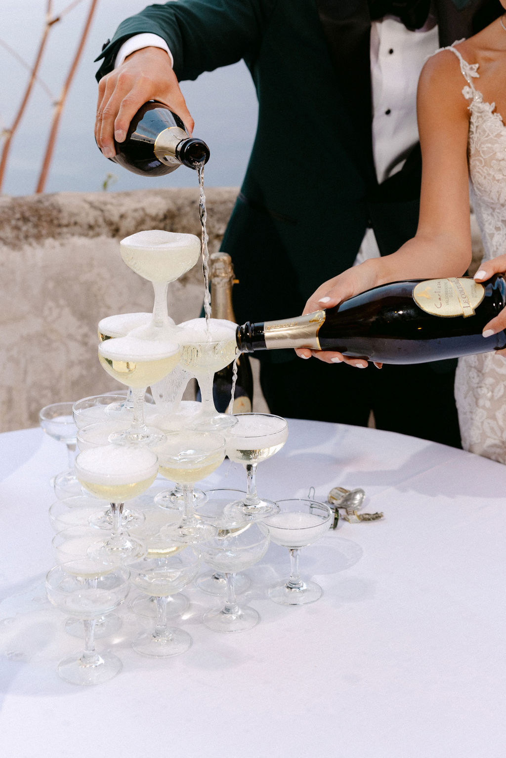 bride and groom pour champagne tower